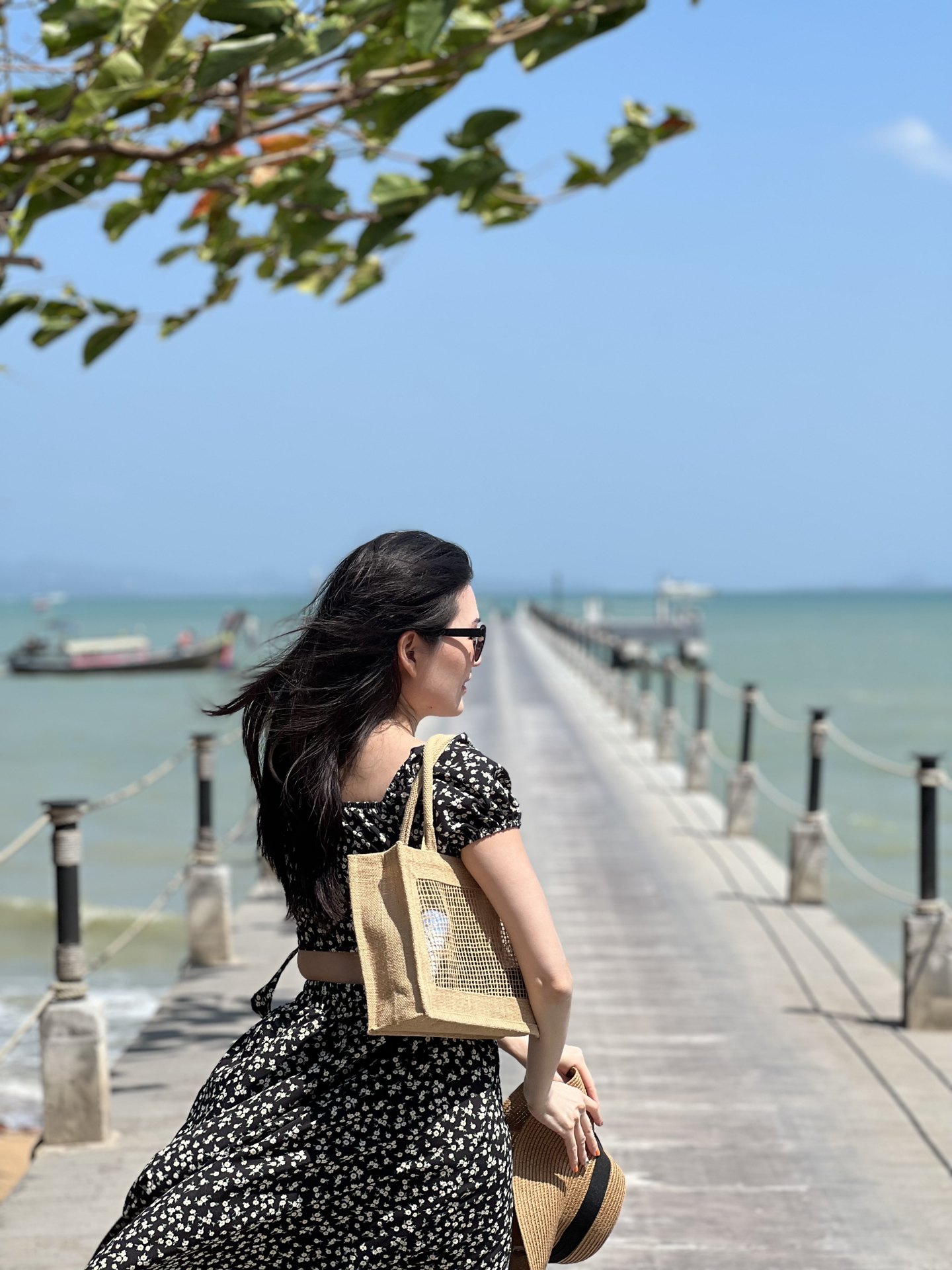 Creator standing at the start of a long pier on Coconut Island