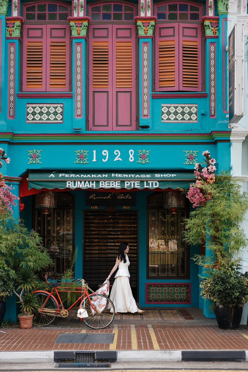 Rumah Bebe’s turquoise Peranakan façade with Ki small in the frame